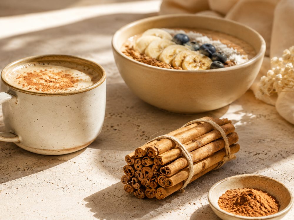 Breakfast setting with a cinnamon latte, porridge bowl and Ceylon Cinnamon quills