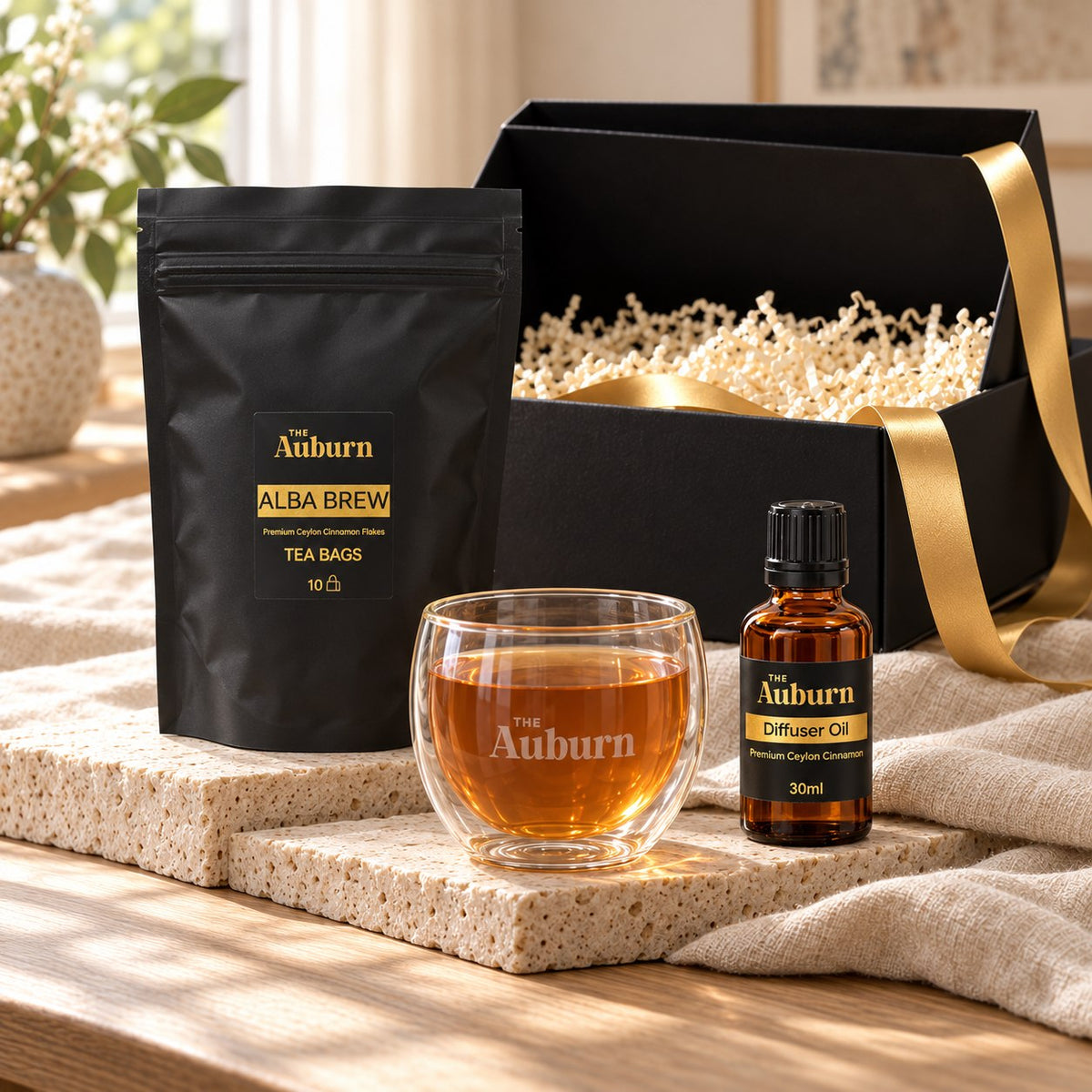 Simply, Me Time hamper: an Auburn glass mug, a box of Alba Brew tea bags and a bottle of cinnamon diffuser oil.