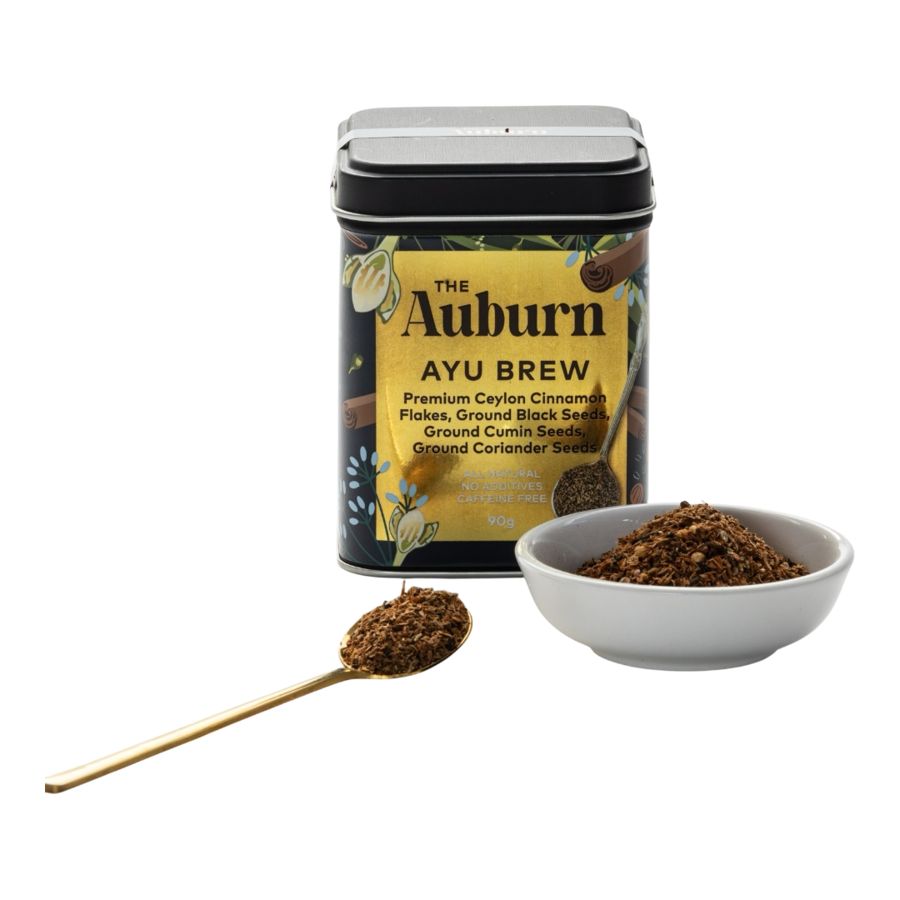 Ayu Brew tin with a bowl and gold spoon of the blend