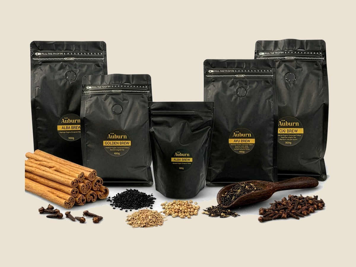 The Auburn refill pouches in 200g, 400g and 900g beside cinnamon quills, cloves and seeds
