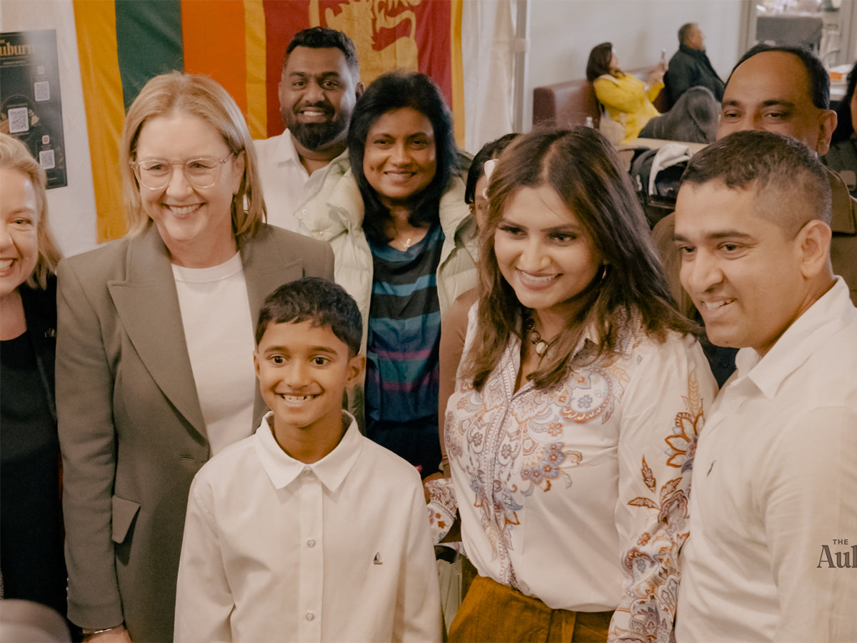 A portrait shot of the team pouring brews at the stall.