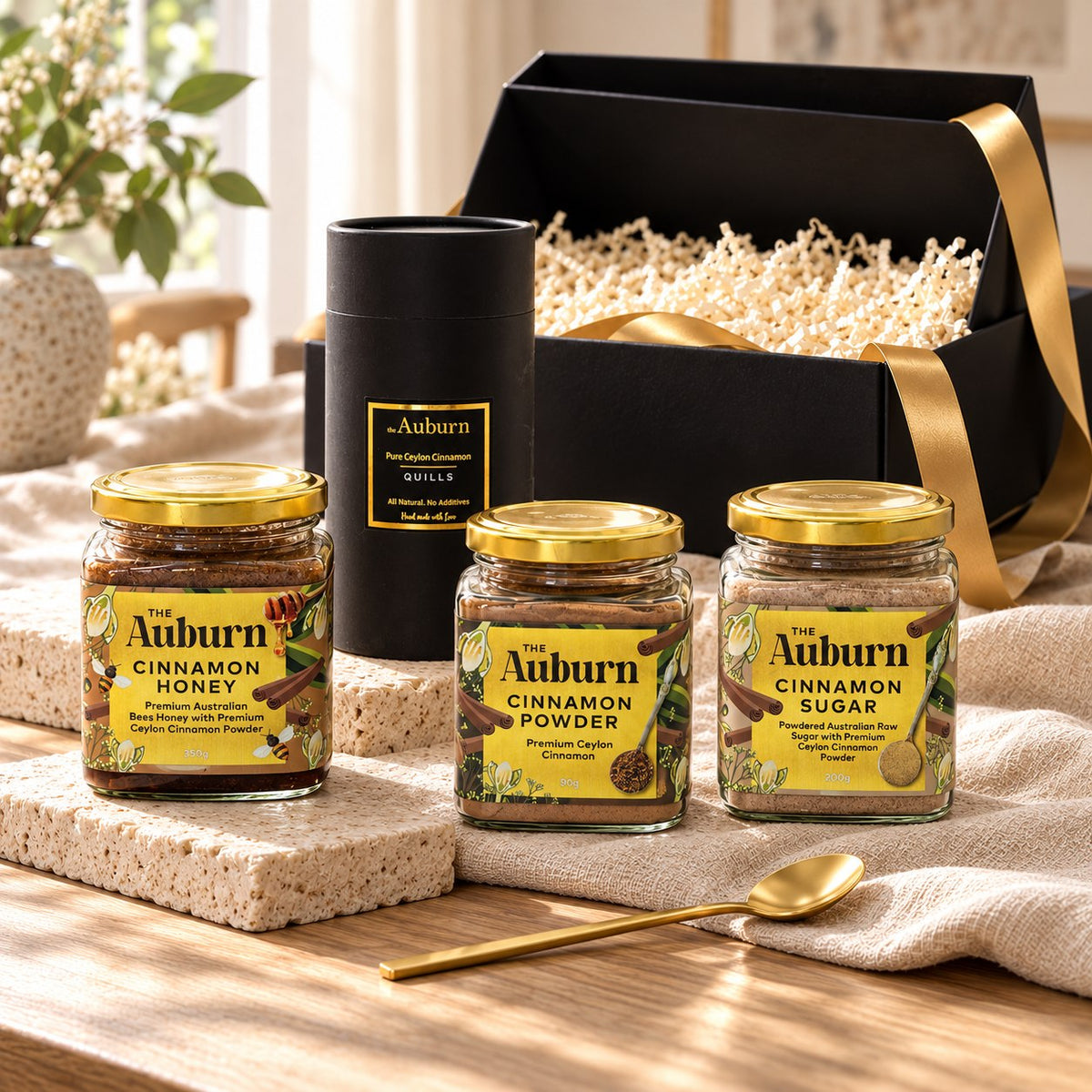 BAKING it is hamper: a jar of cinnamon honey, cinnamon quills, a jar of cinnamon powder, a jar of cinnamon sugar and a gold tea spoon.