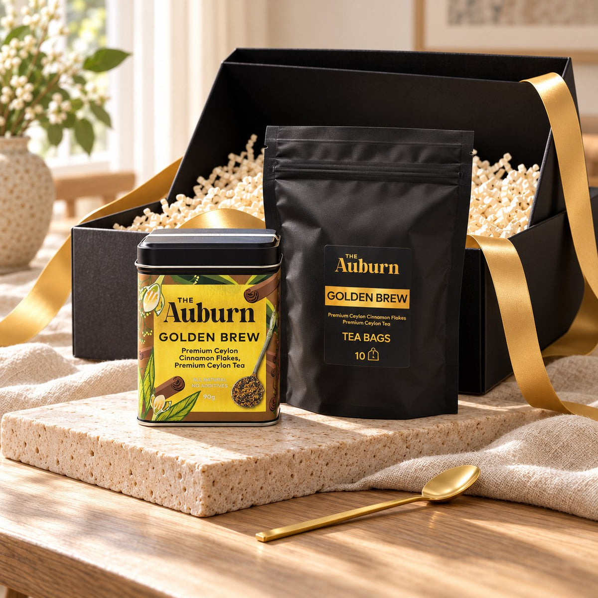 The Little Thank You hamper: a Golden Brew tin, a box of Golden Brew tea bags and a gold tea spoon.