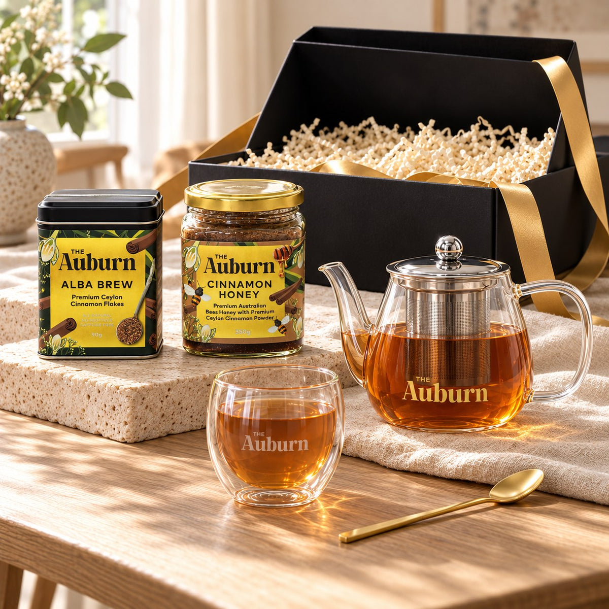 Thank You SO MUCH hamper: an Alba Brew tin, a jar of cinnamon honey, a glass teapot, a glass mug and a gold tea spoon.