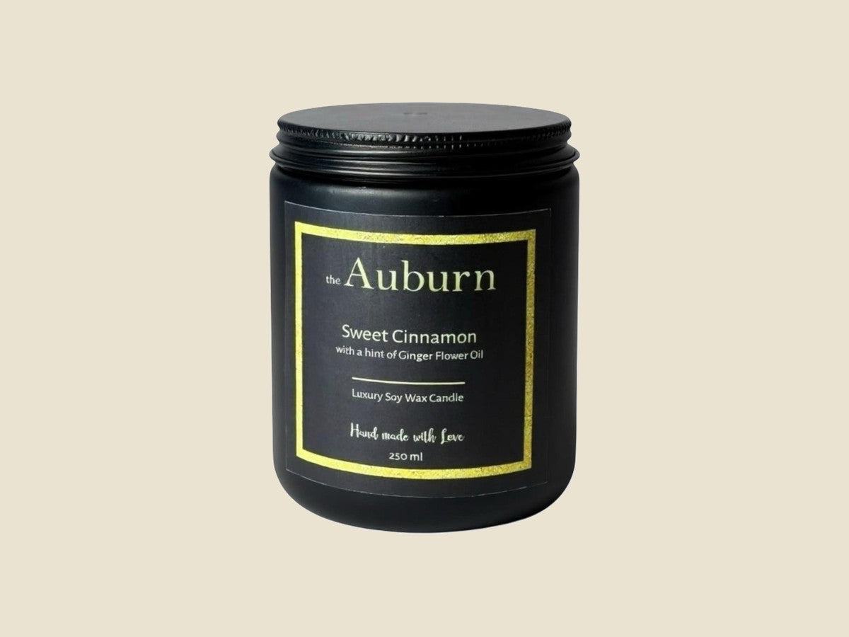 The Auburn Sweet Cinnamon soy wax candle in a matte black jar