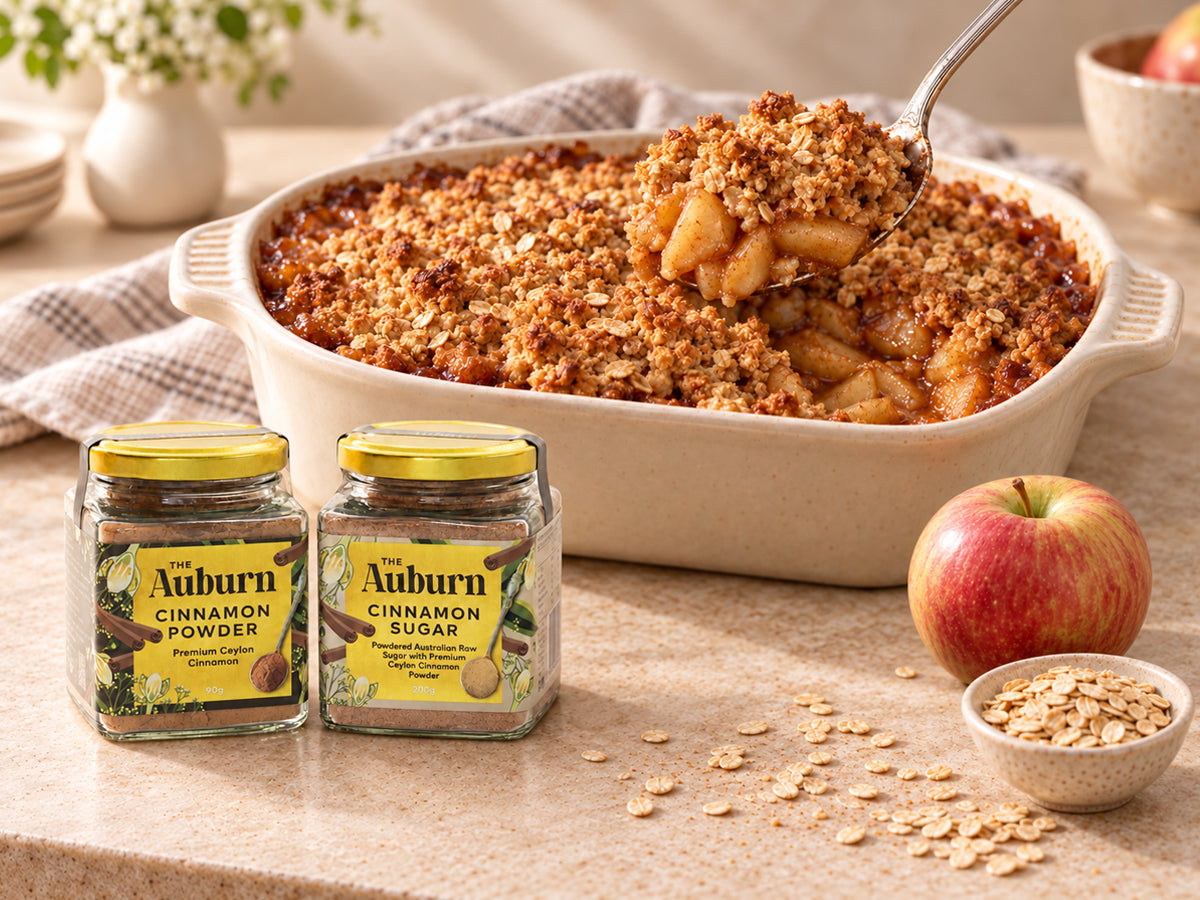 Cinnamon apple crumble in a baking dish with a golden, sugared top.