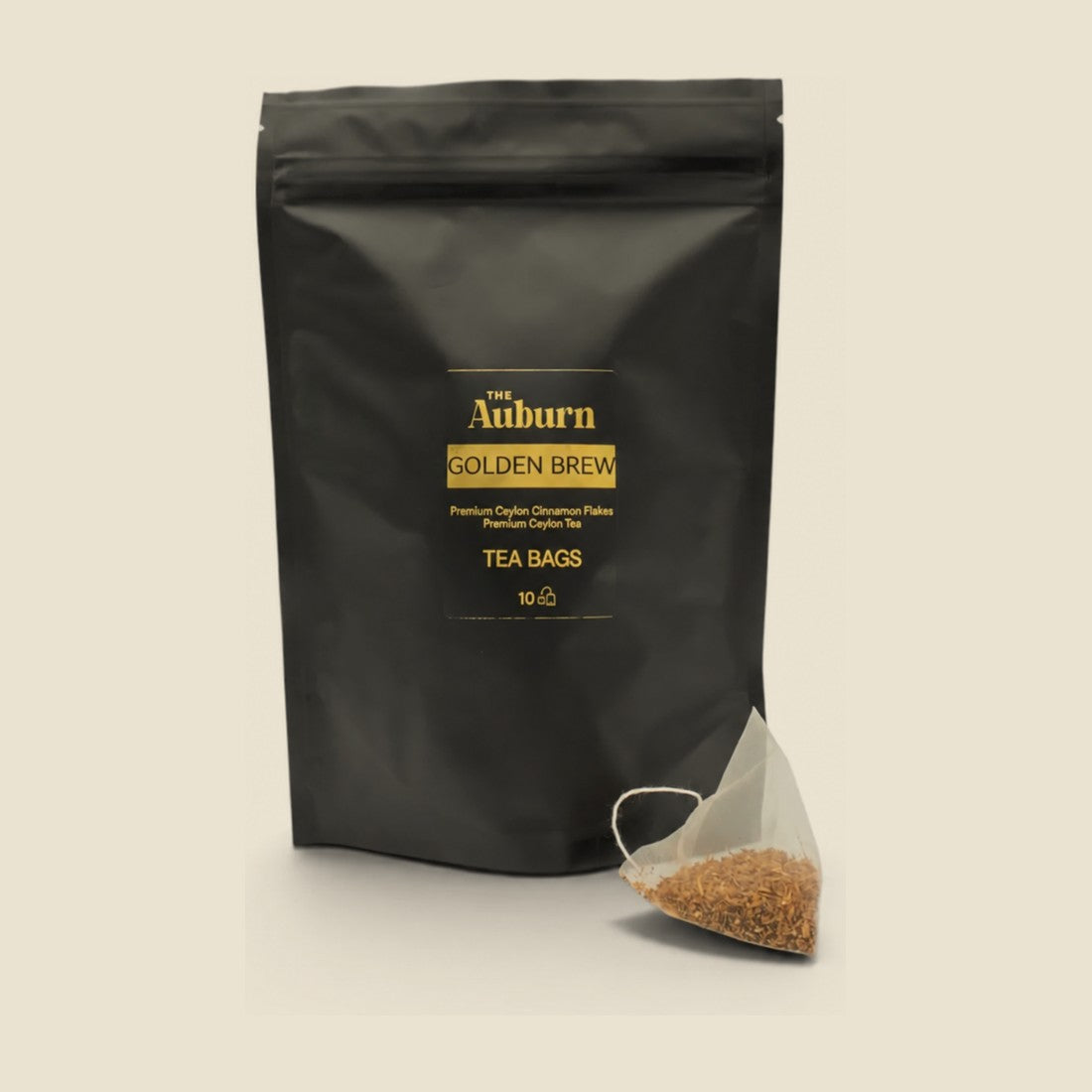 Golden Brew tea bag pouch with a pyramid bag of cinnamon and Ceylon tea in front